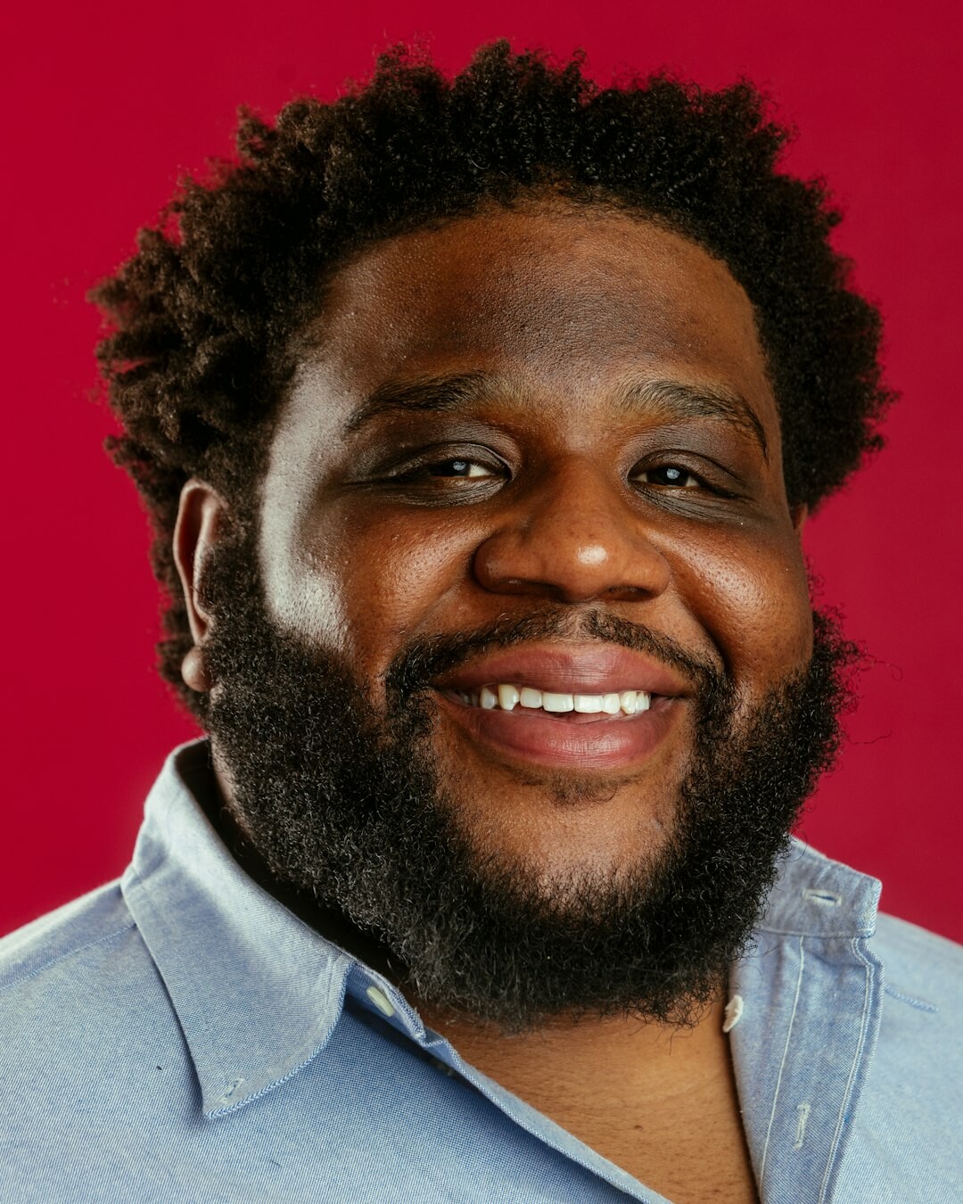 Studio portrait of a man with short beard smiling