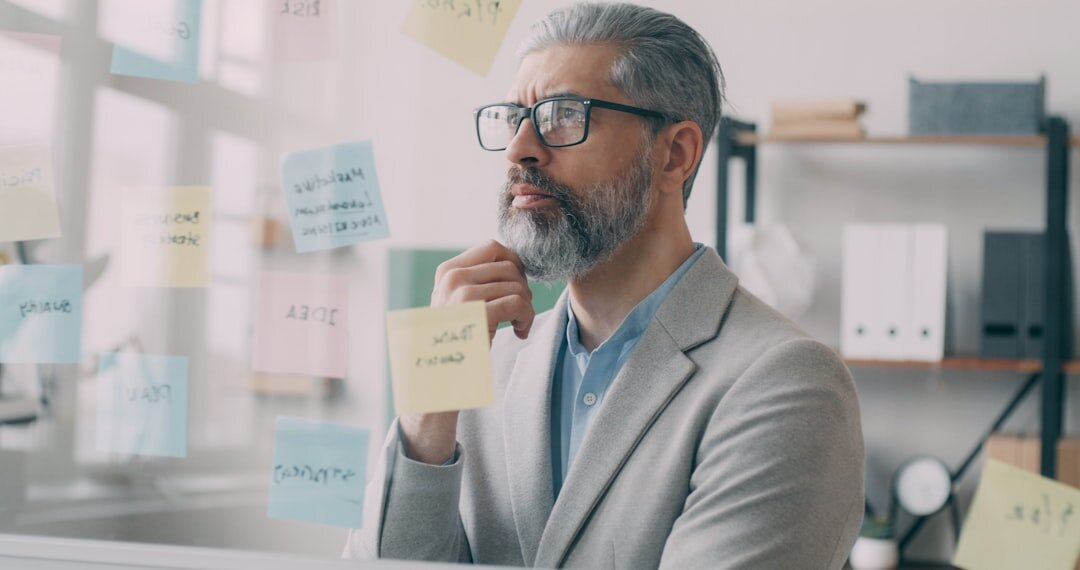 Senior economic analyst looking thoughtfully to the side