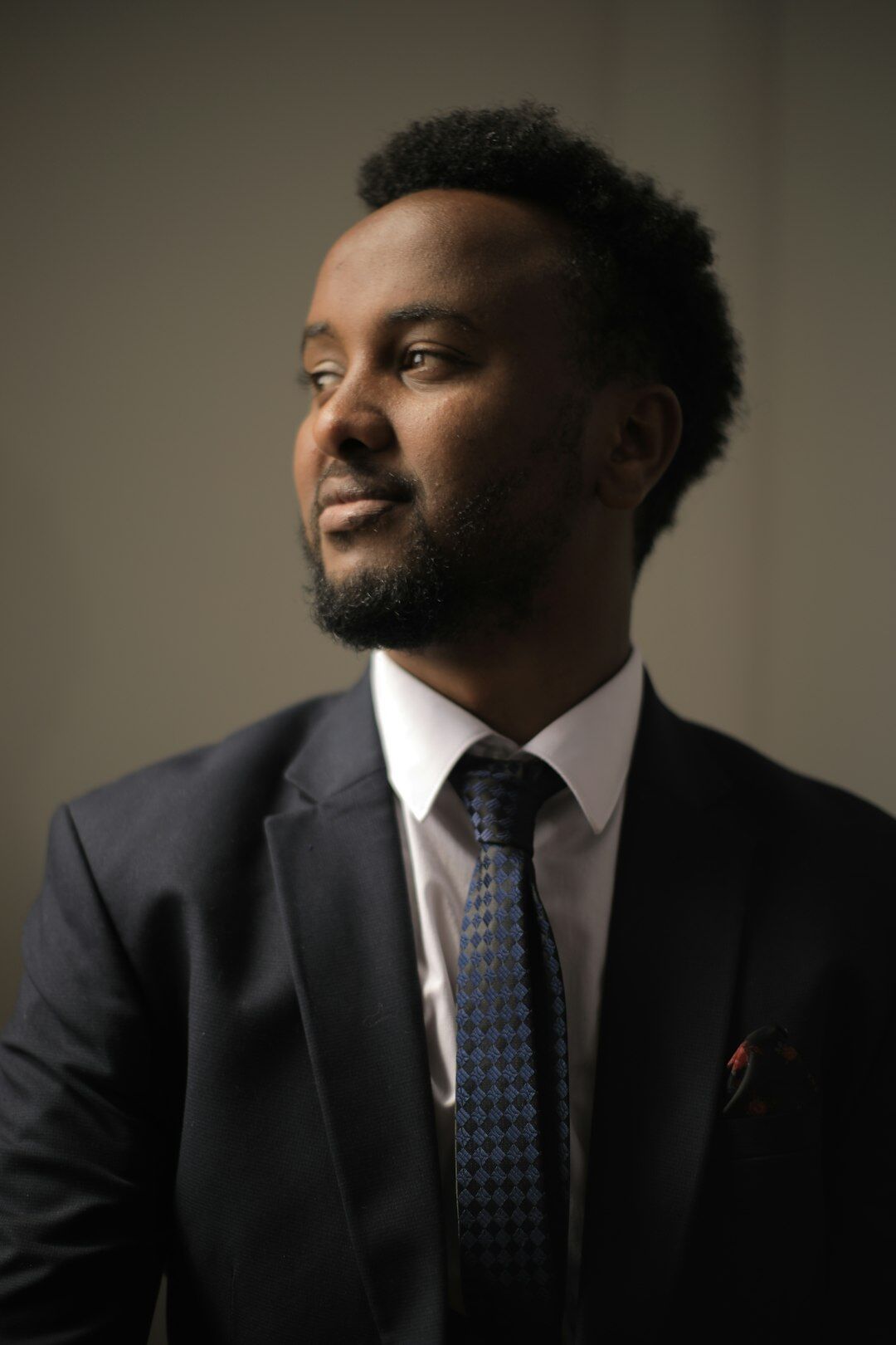 Studio portrait of a man in a suit smiling